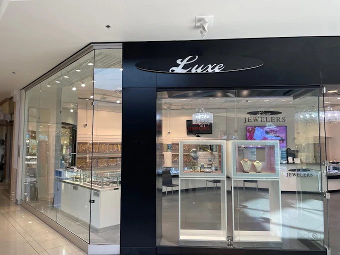 Luxe Jewelers glass storefront and showroom, photographed from the mall walkway