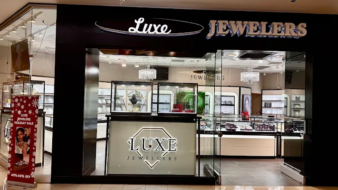 Luxe Jewelers storefront with black signage and illuminated jewelry displays
